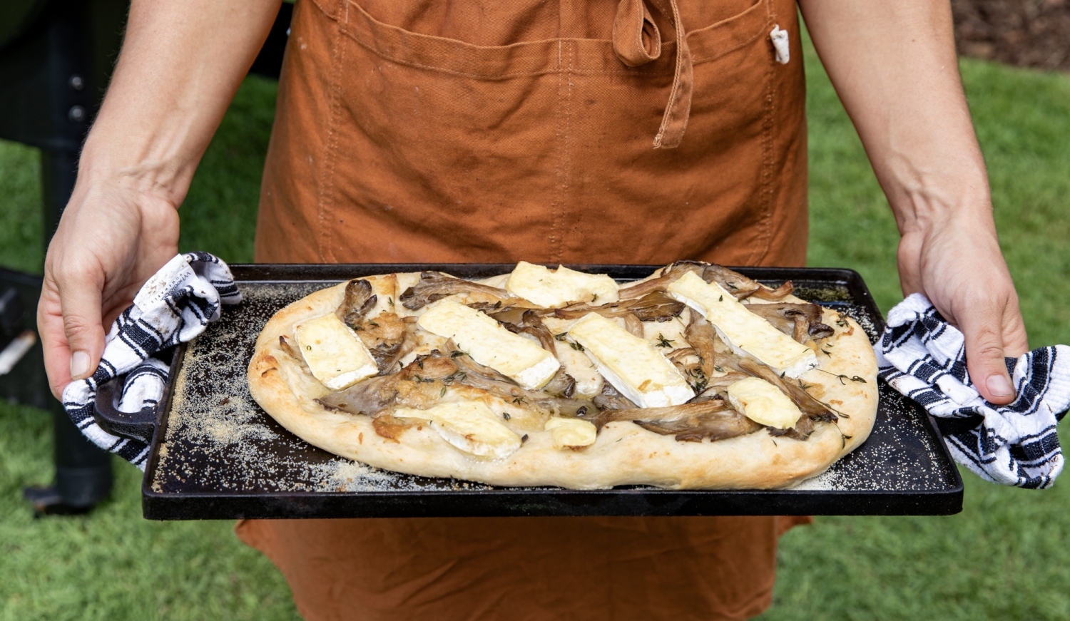 Traeger guide delicious smoked cheesy confit garlic and mushroom pizza